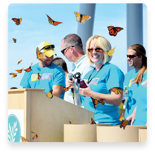 group on stage releasing monarch butterflies